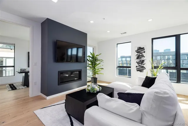 a living room with furniture fireplace and flat screen tv