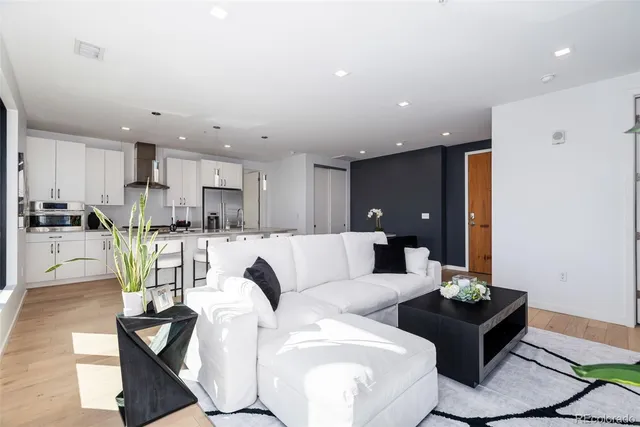 a living room with furniture and kitchen view