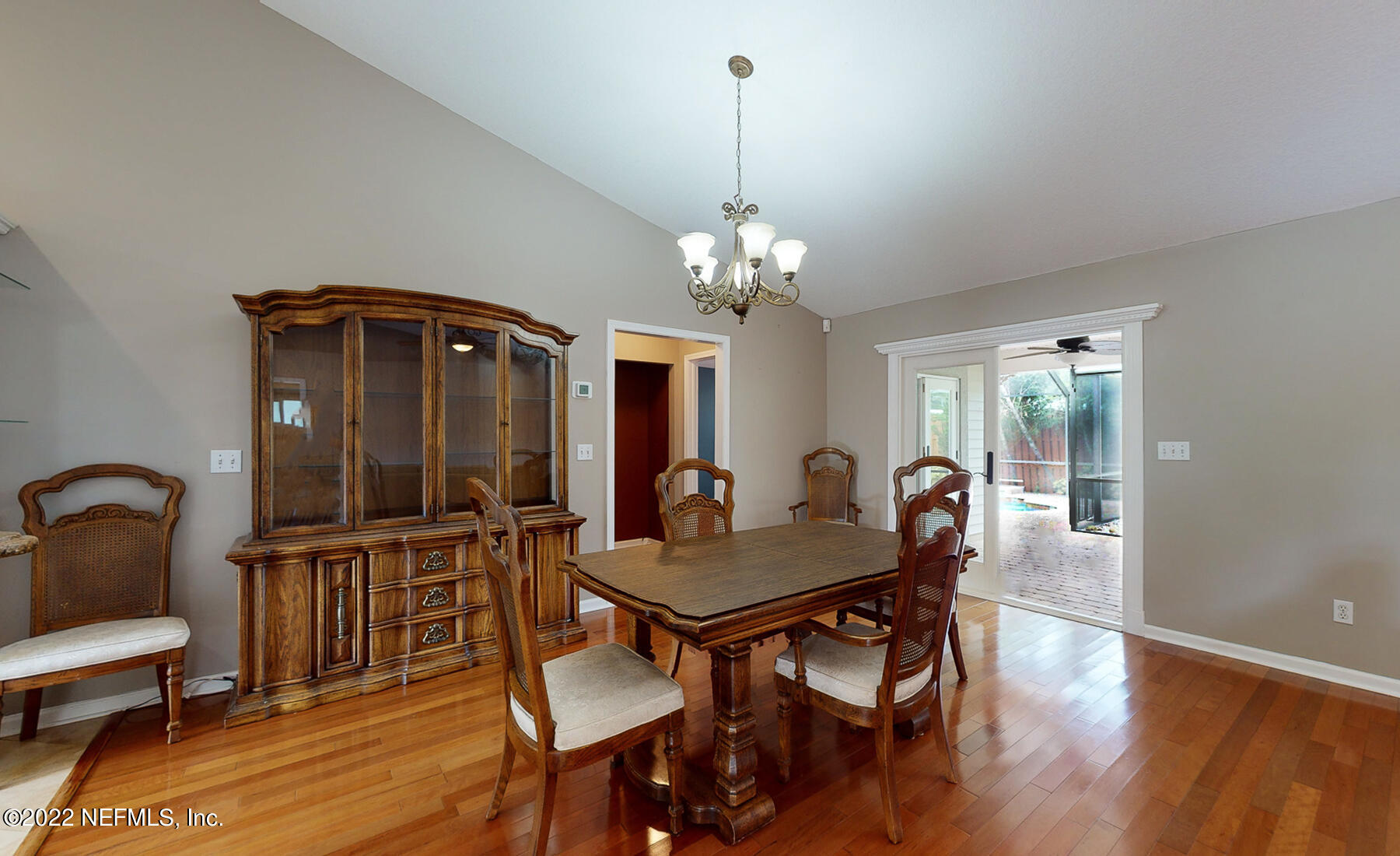 114 Harvard Road St. Augustine, FL 32086 - Photo 13 of 32 a dining room with furniture a chandelier and wooden floor