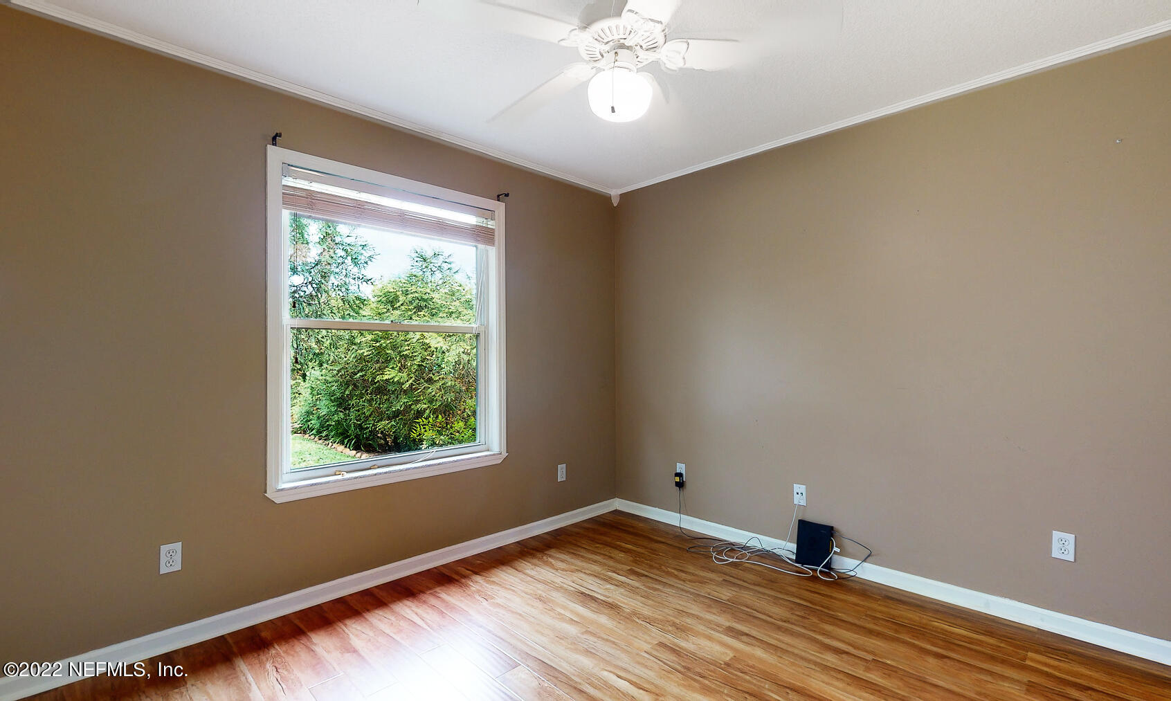 114 Harvard Road St. Augustine, FL 32086 - Photo 19 of 32 a view of an empty room with wooden floor and a window