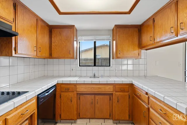a kitchen with a sink appliances and cabinets