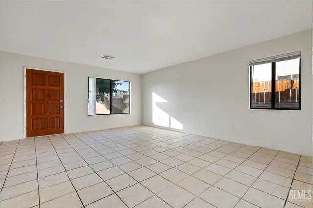 a bedroom with a large bed and a flat screen tv