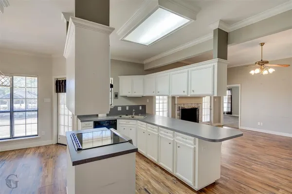 a kitchen with white cabinets and appliances