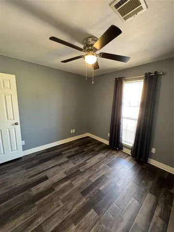 a bathroom with a toilet a sink a mirror and vanity