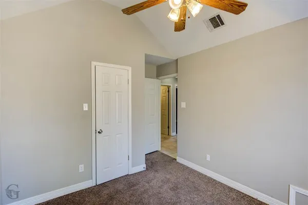 an empty room with a empty space and a ceiling fan