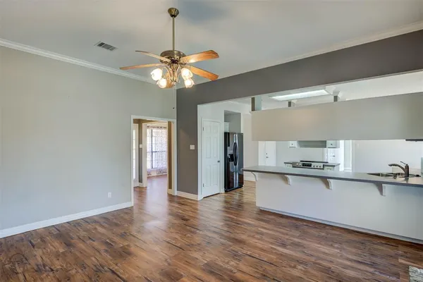 a view of a kitchen counter space wooden floor and a ceiling fan