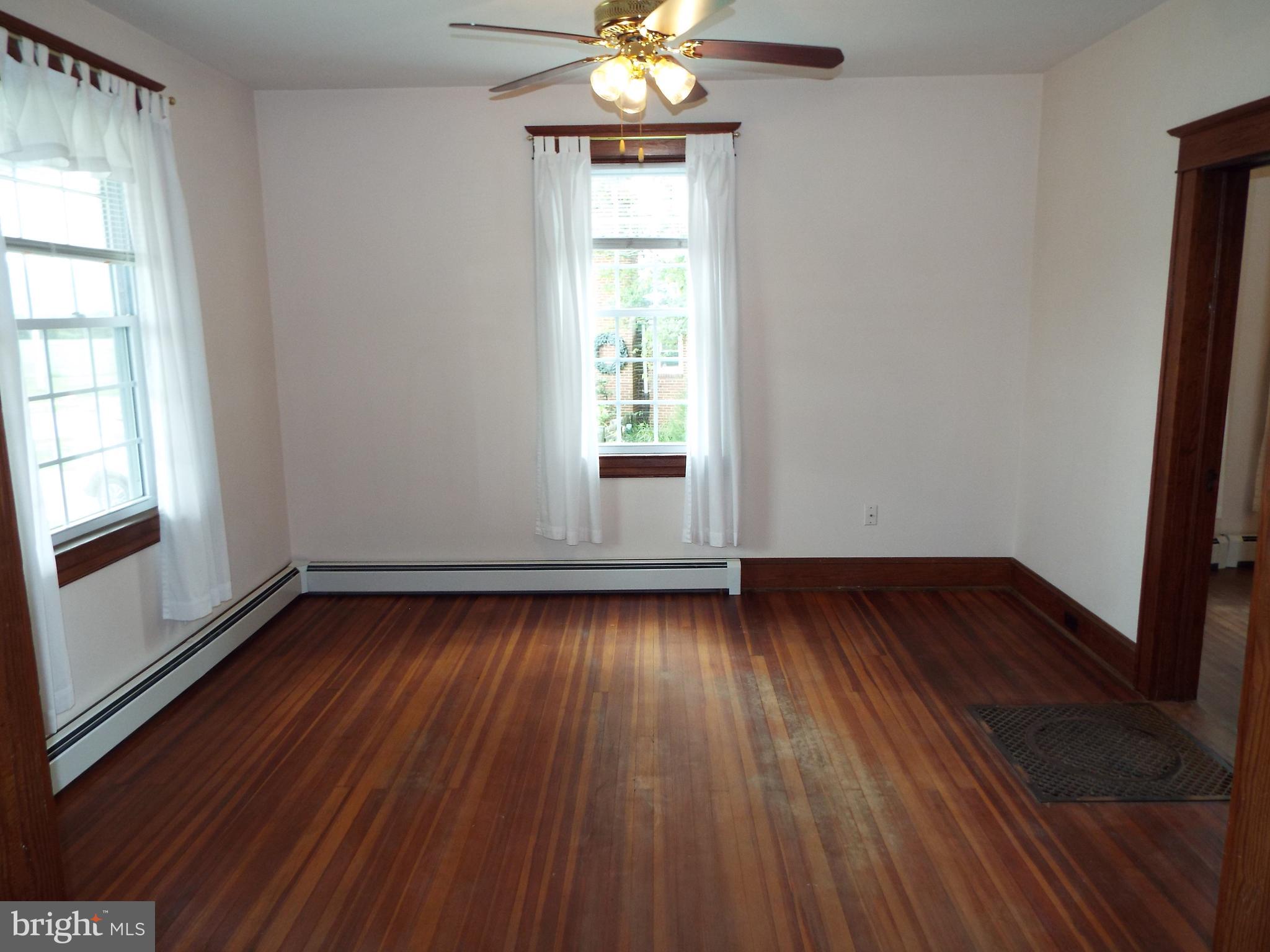 7210 Dogwood Road Baltimore, MD 21244 - Photo 5 of 36 Living Room with rich hardwood floors & fan.
