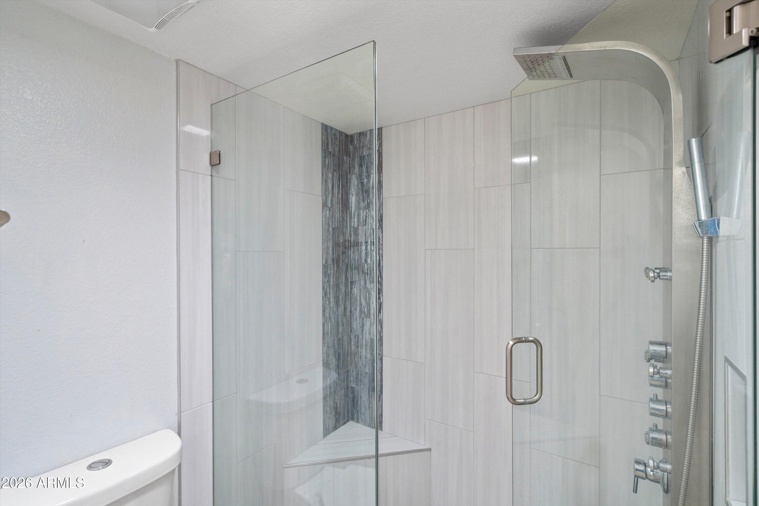 10410 North Cave Creek Road, Unit 1031 Phoenix, AZ 85020 - Photo 17 of 28 a bathroom with a shower and toilet