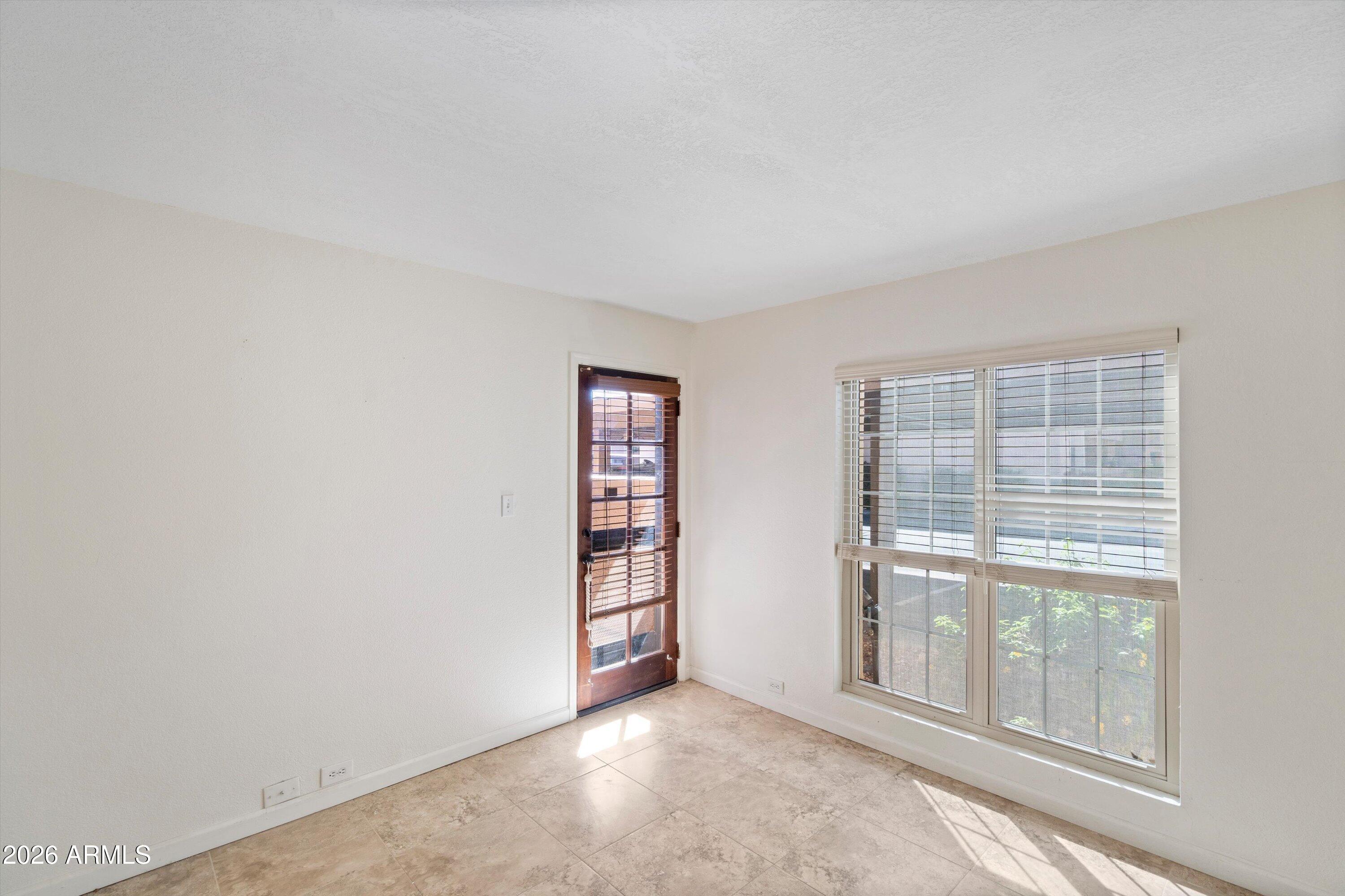 10410 North Cave Creek Road, Unit 1031 Phoenix, AZ 85020 - Photo 20 of 28 an empty room with windows