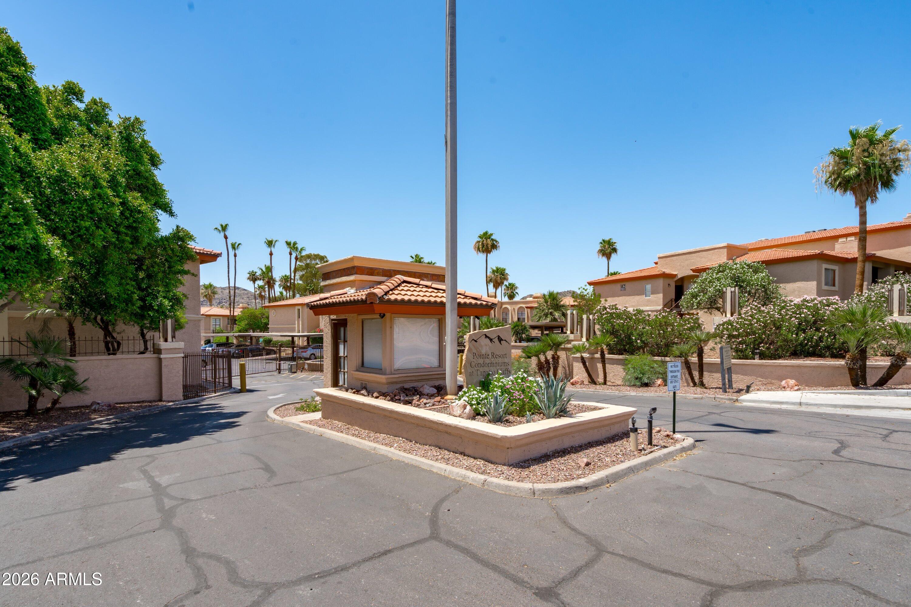 10410 North Cave Creek Road, Unit 1031 Phoenix, AZ 85020 - Photo 2 of 28 a view of a patio with a table and chairs under an umbrella