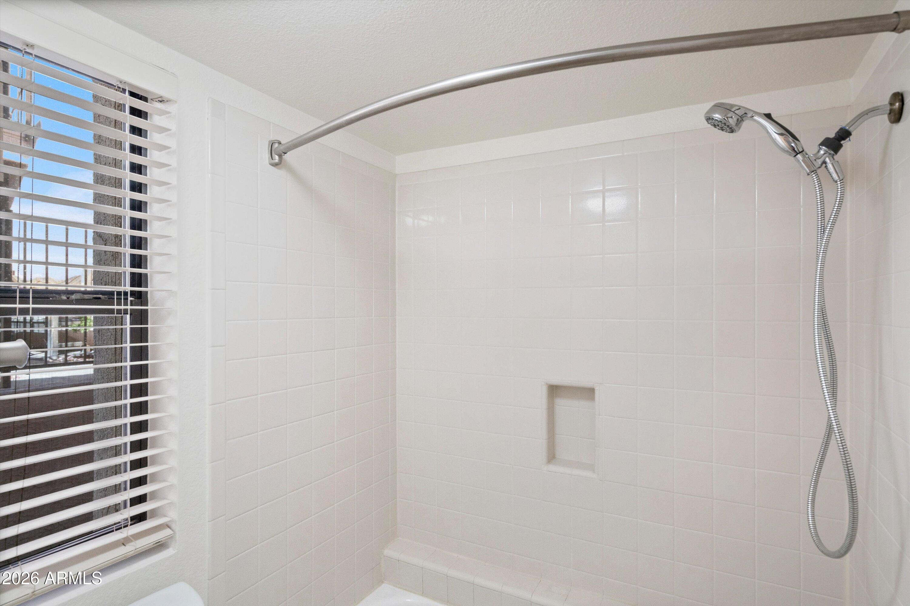 10410 North Cave Creek Road, Unit 1031 Phoenix, AZ 85020 - Photo 24 of 28 a bathroom with a shower and a shower head