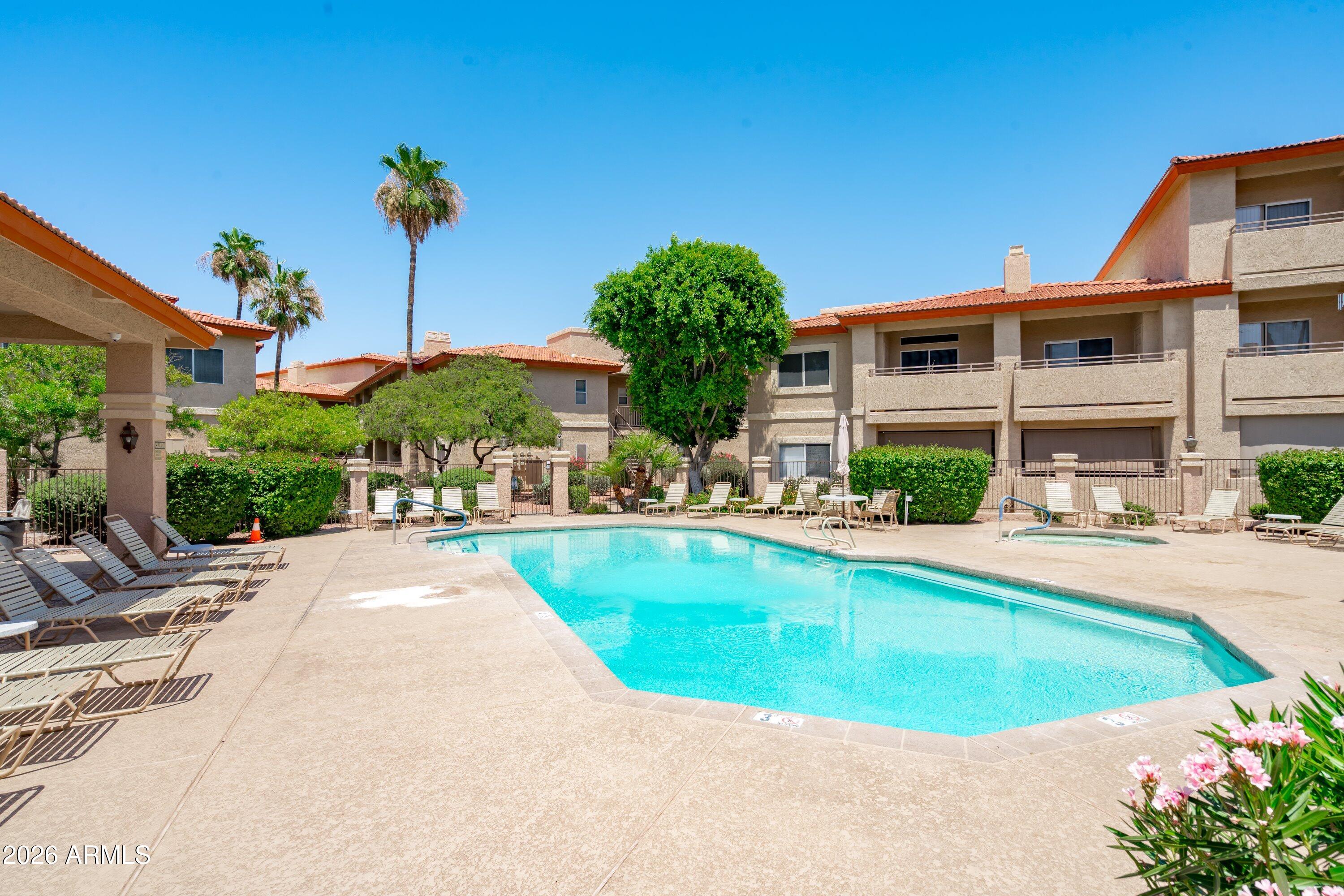 10410 North Cave Creek Road, Unit 1031 Phoenix, AZ 85020 - Photo 3 of 28 a view of a swimming pool with plants