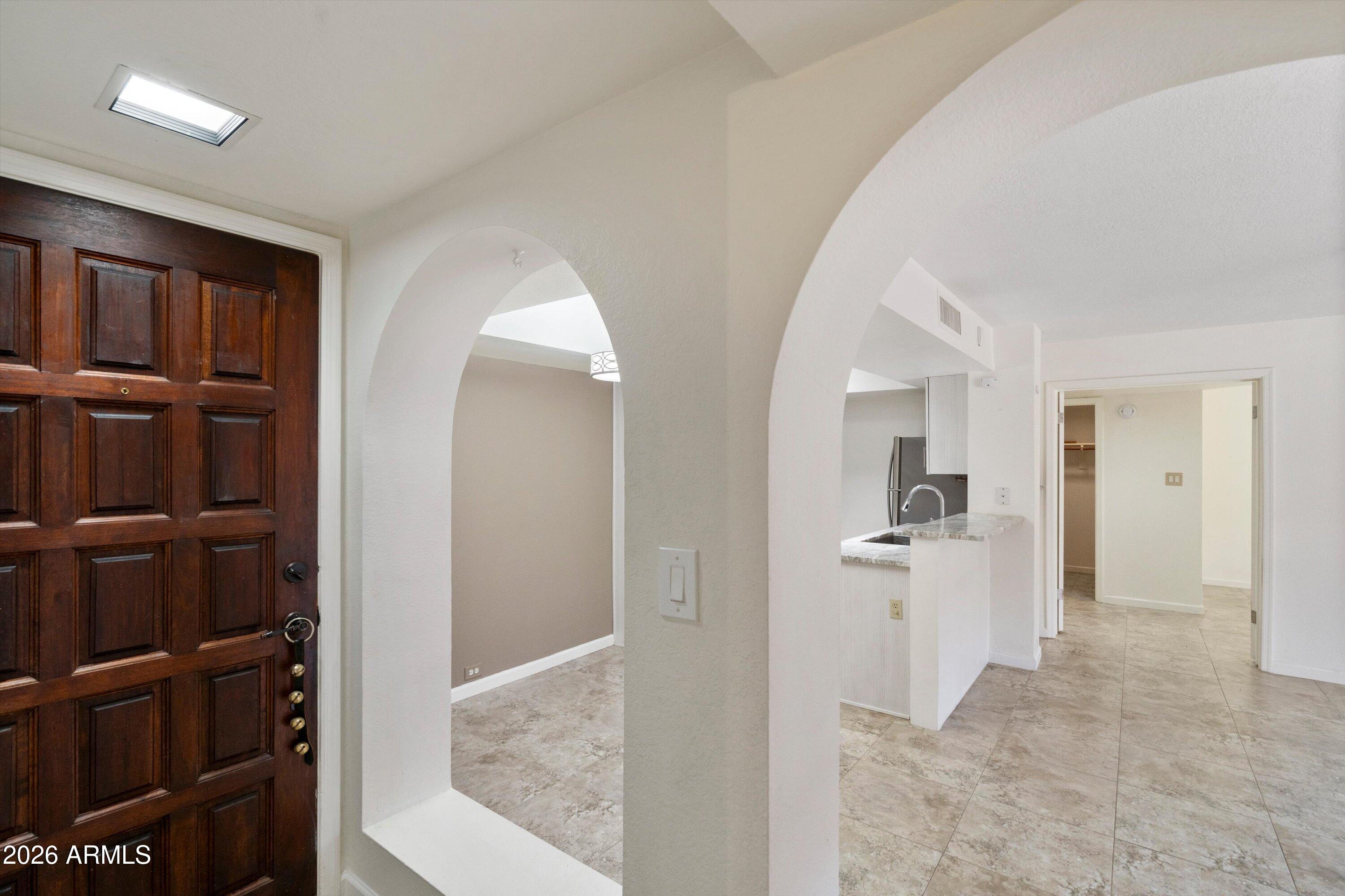 10410 North Cave Creek Road, Unit 1031 Phoenix, AZ 85020 - Photo 4 of 28 a view of a hallway with cabinet and entryway