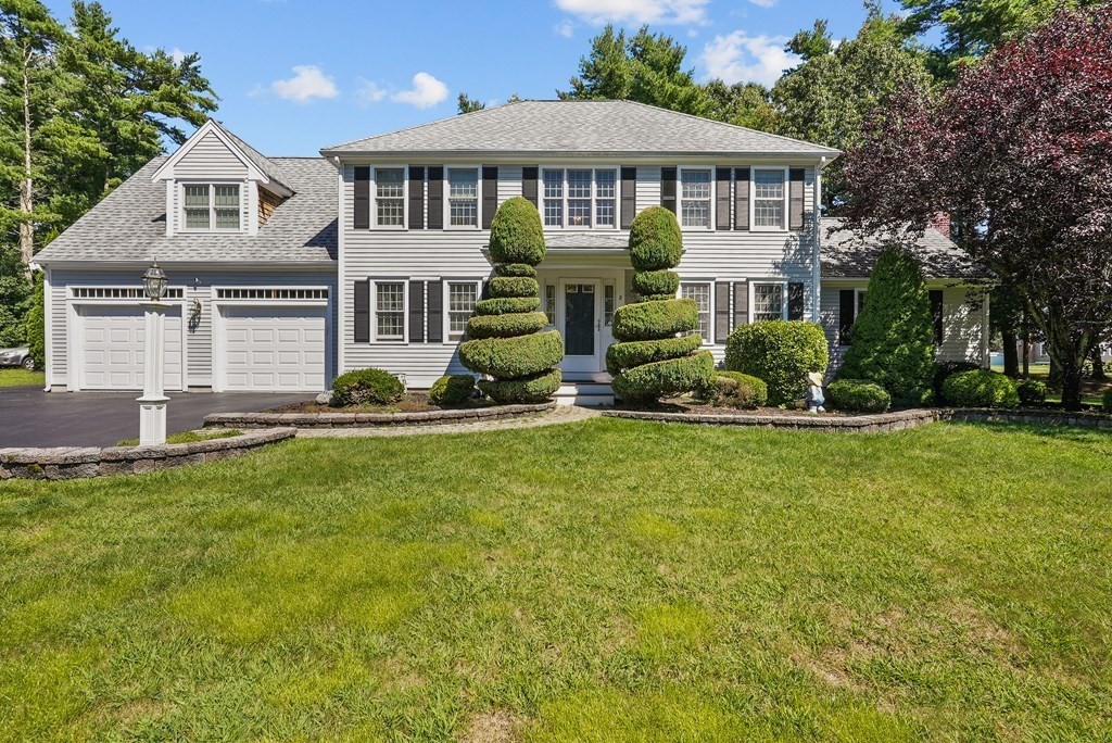 a front view of a house with a yard table and chairs