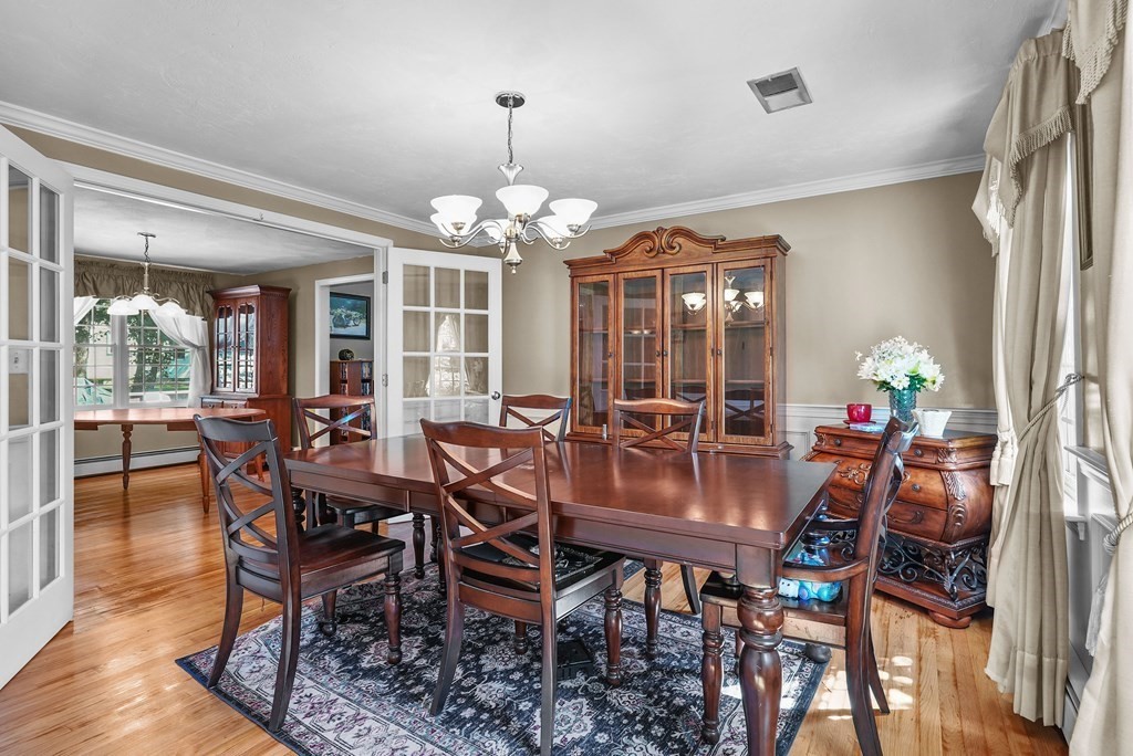 2 Commons Drive Carver, MA 02330 - Photo 11 of 37 a view of a dining room with furniture wooden floor and chandelier