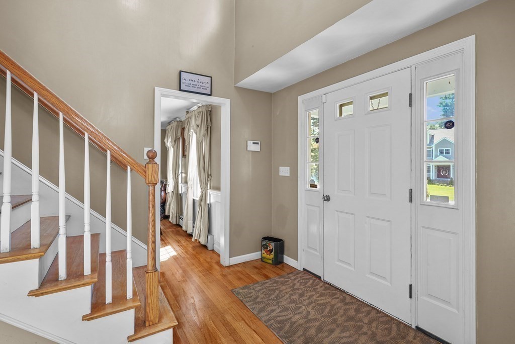 2 Commons Drive Carver, MA 02330 - Photo 16 of 37 a view of a hallway with wooden floor and staircase