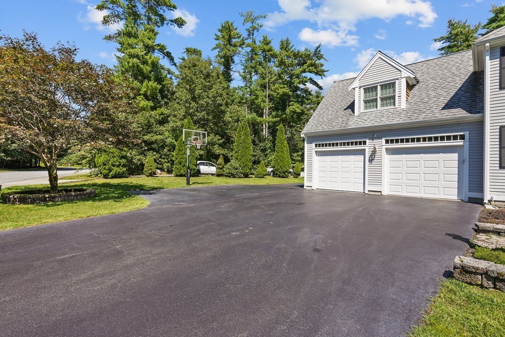 2 Commons Drive Carver, MA 02330 - Photo 4 of 37 a front view of a house with a yard and garage