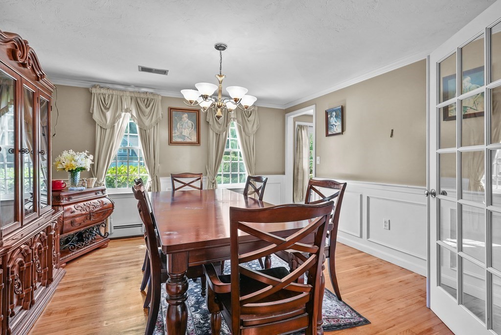 2 Commons Drive Carver, MA 02330 - Photo 10 of 37 a view of a dining room with furniture a chandelier and wooden floor