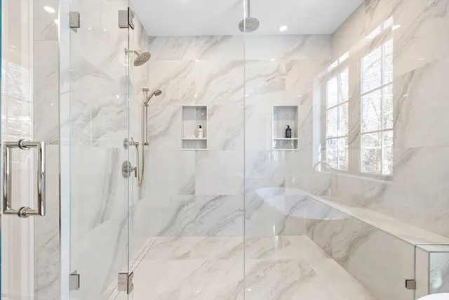 a bathroom with a bathtub and shower