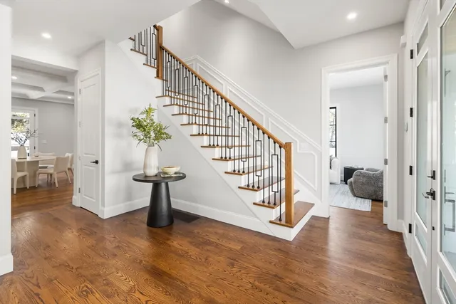 a view of entryway and hall with wooden floor