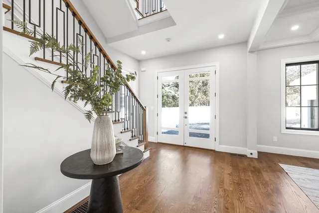 a view of entryway and hall with wooden floor