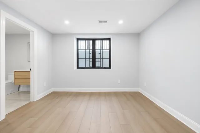 a view of a room with wooden floor and a window