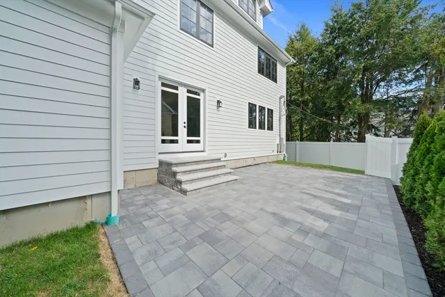 a view of white house with a yard and stairs