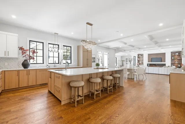 a large white kitchen with lots of counter space and breakfast area