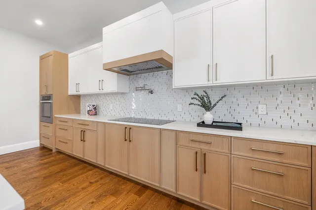 a kitchen with granite countertop white cabinets and white appliances