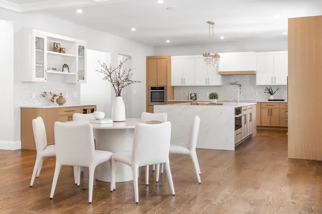 a kitchen with granite countertop a table and chairs in it