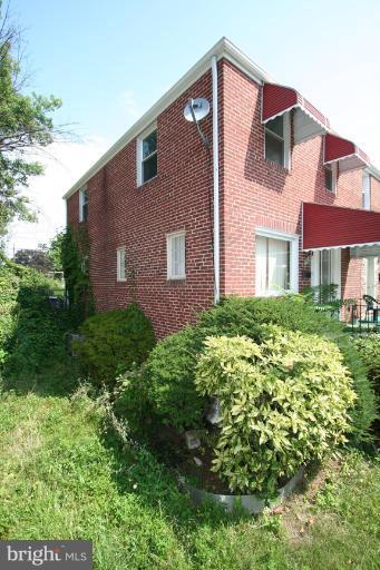 5010 West Hills Road Baltimore, MD 21229 - Photo 2 of 30 a front view of a house with a yard
