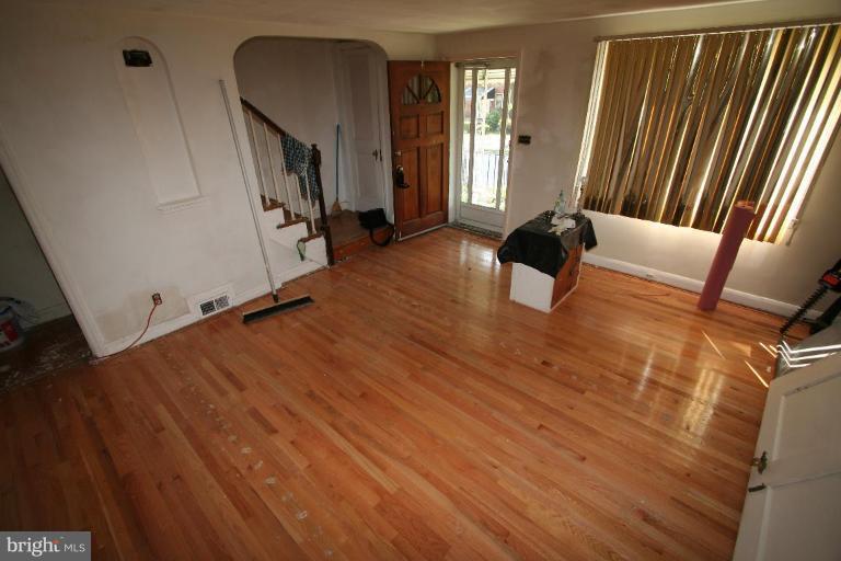 5010 West Hills Road Baltimore, MD 21229 - Photo 12 of 30 a view of an empty room with wooden floor and a window