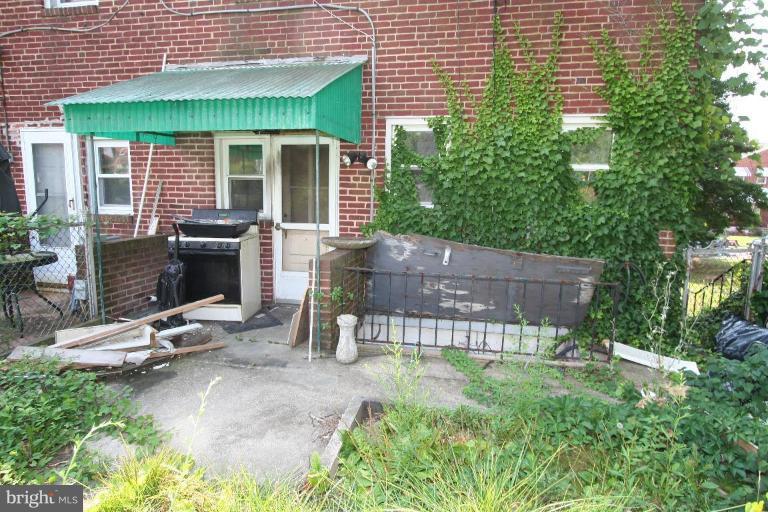 5010 West Hills Road Baltimore, MD 21229 - Photo 5 of 30 a view of a patio with table and chairs and potted plants