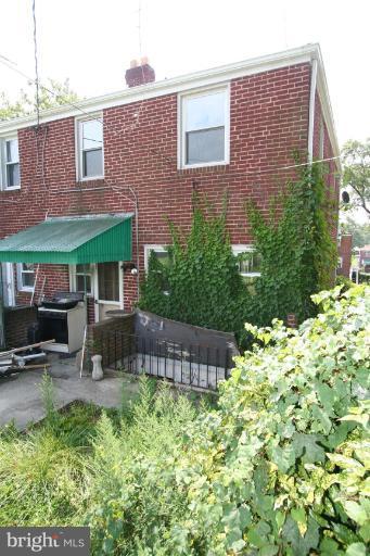 5010 West Hills Road Baltimore, MD 21229 - Photo 6 of 30 a front view of a house with a garden