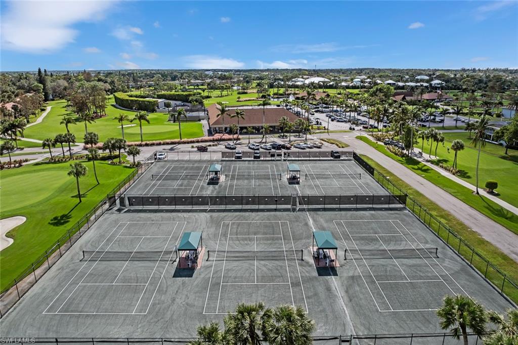 136 Harrison Road, Unit 1 Naples, FL 34112 - Photo 29 of 29 Four hard tennis courts with green surfacing and white line markings