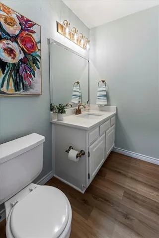 a bathroom with a toilet a sink and mirror