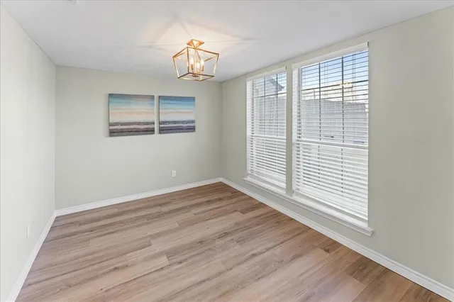 a view of a livingroom with wooden floor and a large window