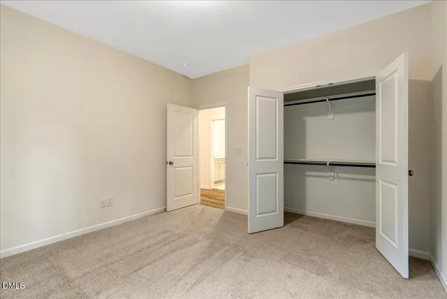 a view of an empty room and closet area