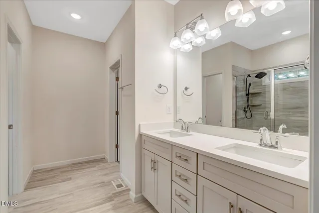a bathroom with a sink double vanity and a mirror