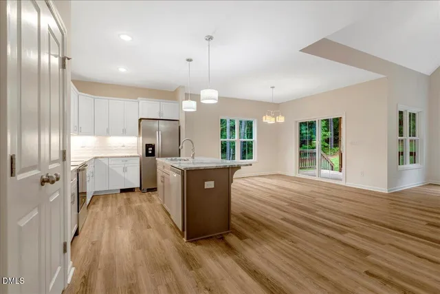 a large kitchen with a lot of counter space and a wooden floor