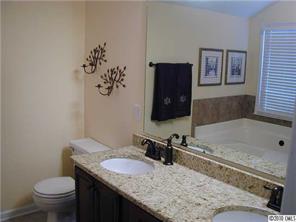 9815 Park Spring Charlotte, NC 28210 - Photo 12 of 15 a bathroom with a granite countertop sink and a toilet