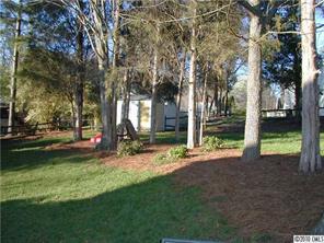 9815 Park Spring Charlotte, NC 28210 - Photo 3 of 15 a view of a house with backyard and tree