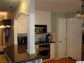 9815 Park Spring Charlotte, NC 28210 - Photo 4 of 15 a kitchen with stainless steel appliances granite countertop a refrigerator and a stove top oven