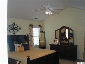 9815 Park Spring Charlotte, NC 28210 - Photo 10 of 15 a bedroom with a bed and a chandelier