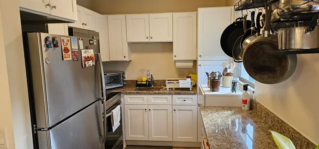 a kitchen with stainless steel appliances a refrigerator a sink and a stove