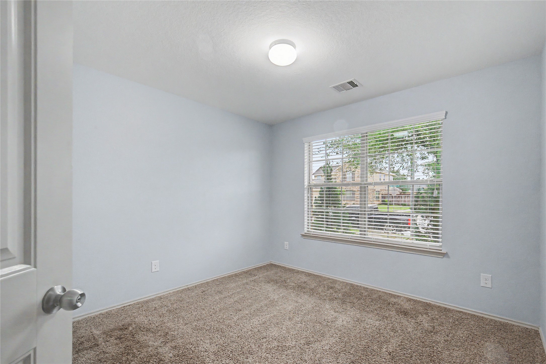 16430 Rodeo River Road Houston, TX 77049 - Photo 6 of 34 a view of an empty room with a window