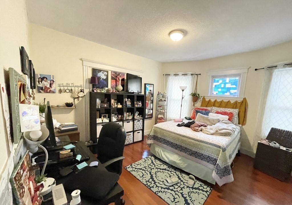 19 Eastman Street, Unit 1 Boston, MA 02125 - Photo 4 of 6 a bedroom with furniture and wooden floor