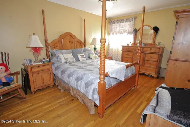 a bed room with a bed window and a mirror