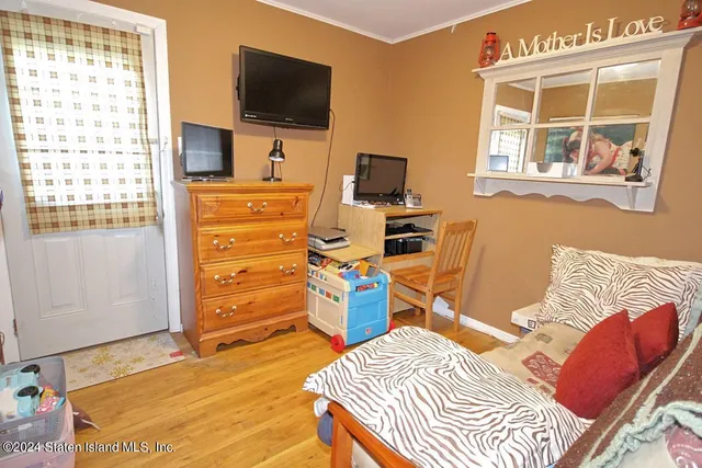 a bedroom with a bed and flat screen tv