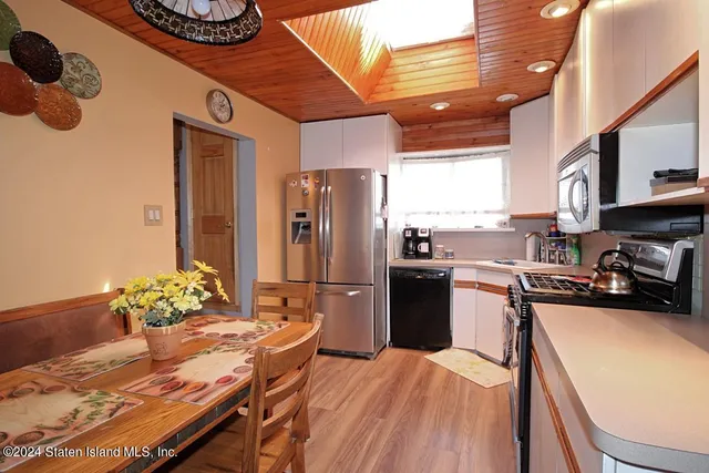 a kitchen with a refrigerator and a stove